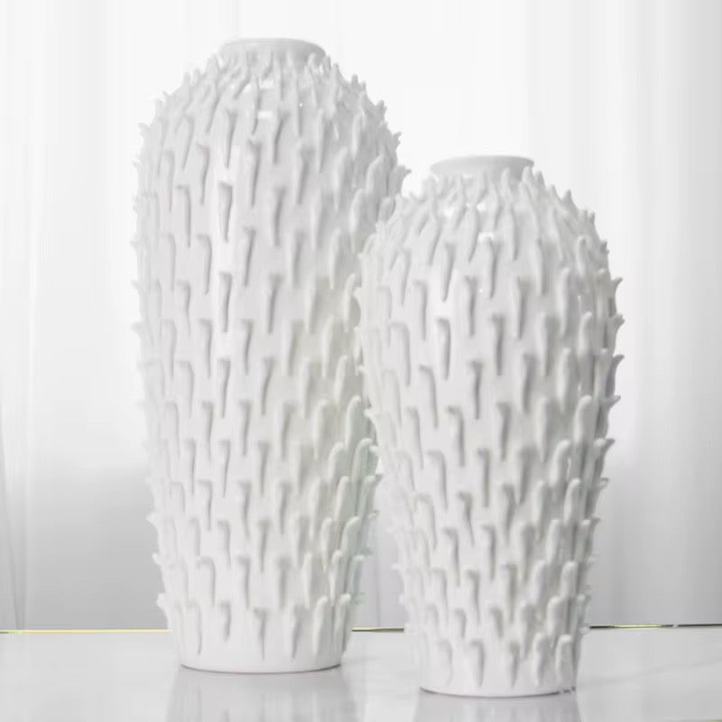 Two white textured vases on a light gray background