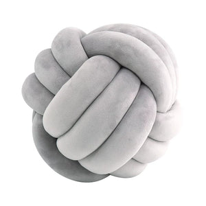 Vibrant velvet knot pillow with a pop of color for a modern touch