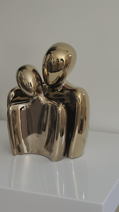 Romantica couple ceramic figurine with gold color on table showing